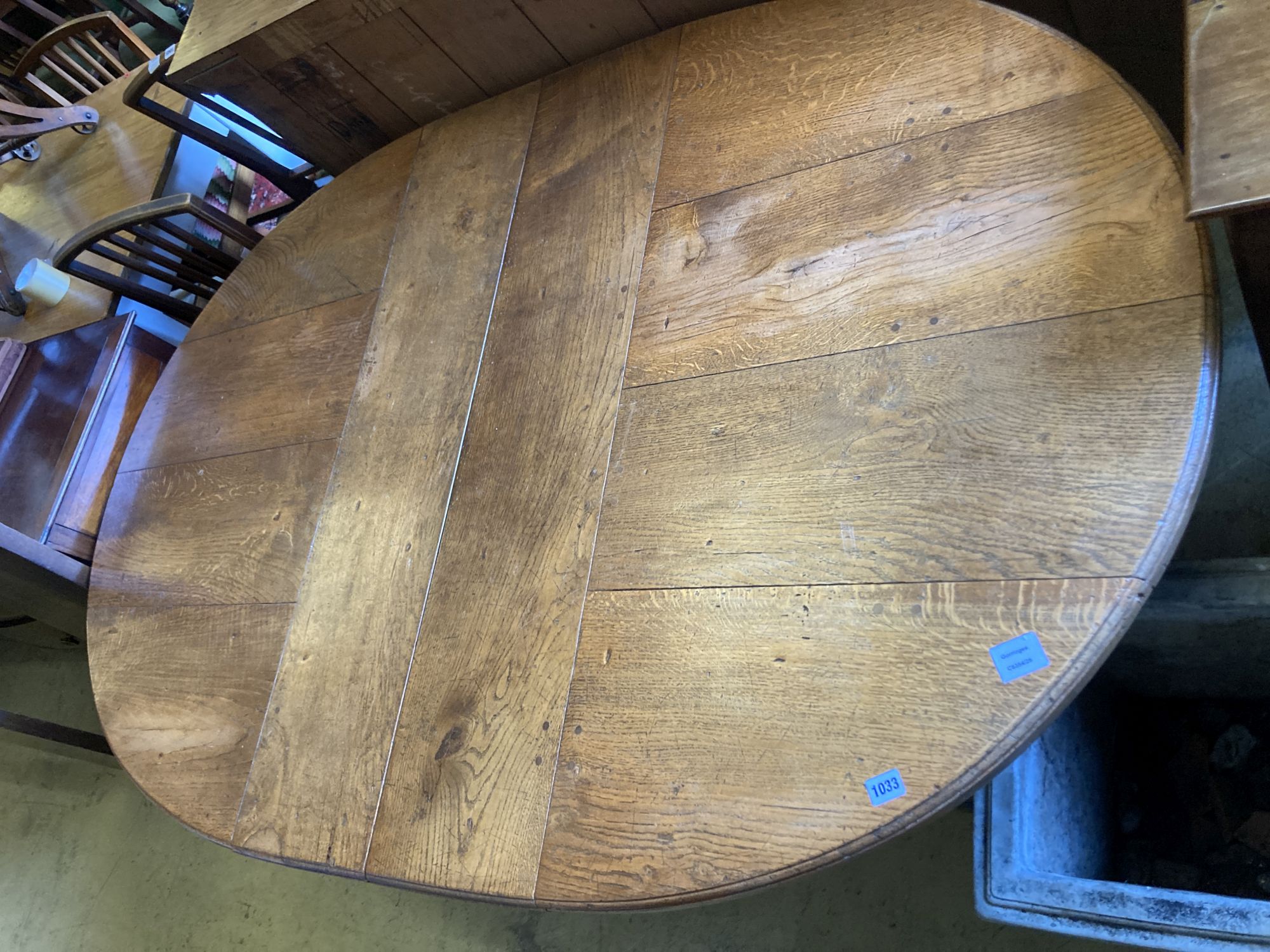 A 17th century style oak dining table, length 268cm extended (two spare leaves), width 122cm, height 74cm